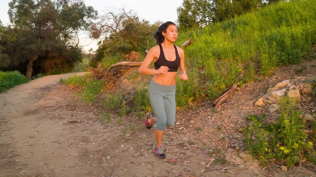 Athletic woman trail running in the hills surrounding Los Angeles.