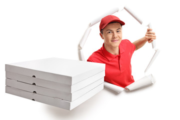 Teen delivery boy breaking through paper