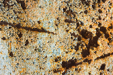 Rusty metal with peeling cracked paint background