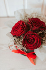 Romantic luxury red roses in a black gift box with red ribbon.