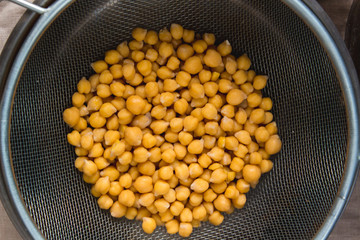 Boiled chikpea in sieve close up. Source of protein for vegan healthy diet.