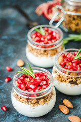Pomegranate greek yogurt mousse on dark blue background. Selective focus, space for text. 