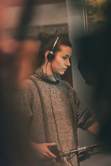 Naklejka premium Behind the scene. Female cameraman shooting film scene with camera