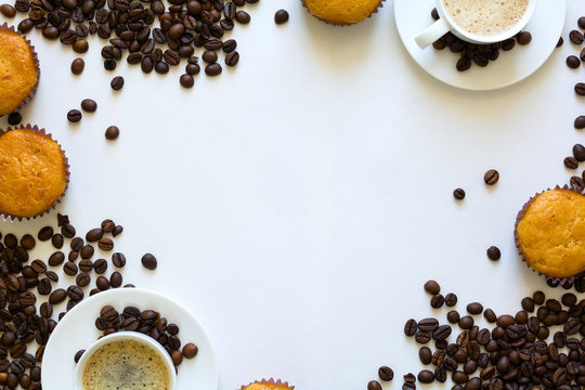 Cup of espresso with muffins and coffee beans on white table. Top view