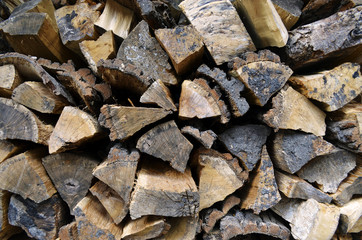 Detailed view to stacked and seasoned firewood for an open-hearth fireplace