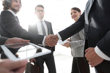 employees look at the handshake business partners