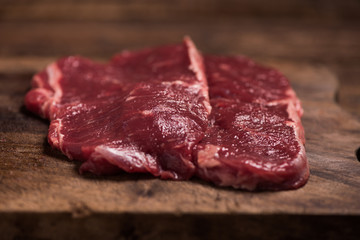A raw beef steak marble on a black background