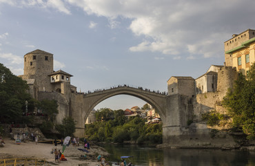 People on the small beach under the famous Stari Most bridge in Mostar