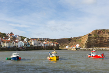 Staithes Yorkshire uk boats in harbour in seaside town and tourist destination