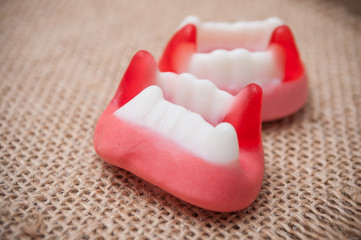 closeup of traditional candies in shaped teeth on hessian background