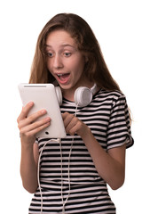 Photo of a young cheerful girl, isolated on white background. Looking at the camera showing the display of the tablet computer.