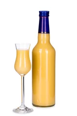 Gordijnen Bottle and glass of egg liqueur isolated on white background © orinocoArt