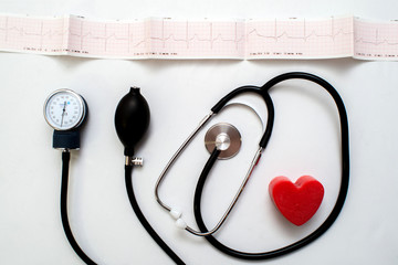 Red heart and a stethoscope on desk