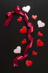 bow, ribbon with hearts on a black background
