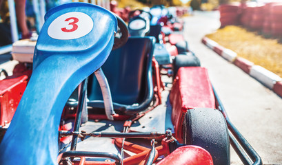 Go kart car parked next to track side - obrazy, fototapety, plakaty