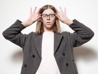 Androgynous young man with coat. Studio portrait