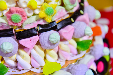 Close up of a cake made with sugary and chewy candies, chupa chups