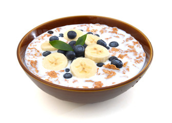 milk, bran and raisin cereal in a bowl , top view