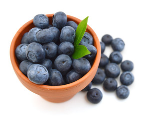 bowl of fresh blueberries on white background