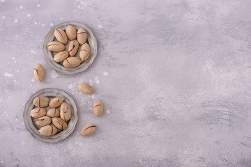 Fototapeta na wymiar Pecan nuts in plate and scattered