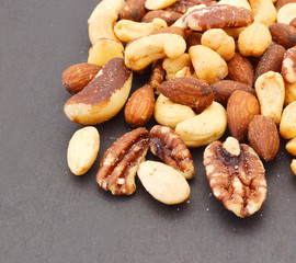 Mix nuts, dry fruits and chocolate on black  background