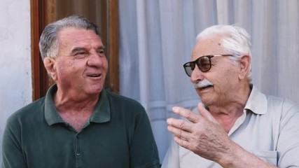 happy and smiling old men talking - Powered by Adobe