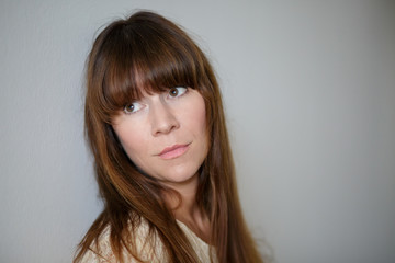 Woman with bangs looking serious