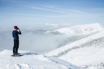 Man drinking from cup on top of Carpathian mountains