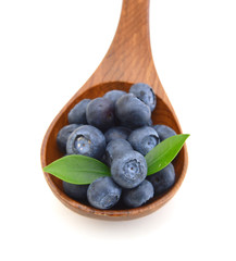 Blueberries and wooden spoon on white background