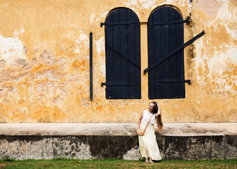 Woman near an old building