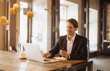 Adult serious man has business conversations using on-line mobile application. Developer...