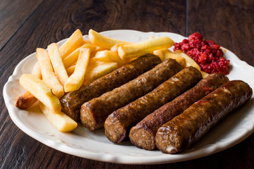 Balkan Cevapcici Kofta / Kofte with Potatoes and Tomato Sauce.