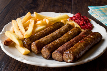 Balkan Cevapcici Kofta / Kofte with Potatoes and Tomato Sauce.