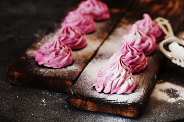 Pink homemade zephyr or marshmallow on dark background