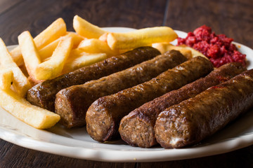 Balkan Cevapcici Kofta / Kofte with Potatoes and Tomato Sauce.