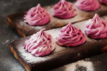 Pink homemade zephyr or marshmallow on dark background