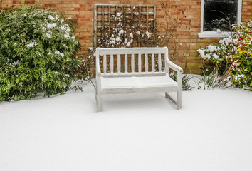 Wooden bench covered in snow