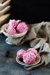 Pink homemade zephyr or marshmallow on dark background