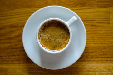 close-up of a cup of coffee high point view on wooden background