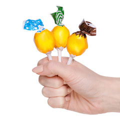 Lolipop in hand on white background isolation