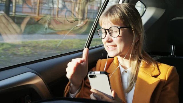 Young Woman Angry During a Phone Call in the Moving Car