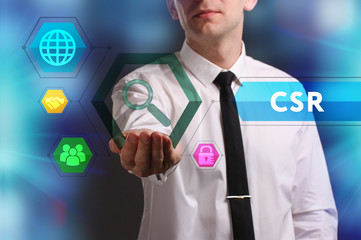 Business, Technology, Internet and network concept. Young businessman working on a virtual screen of the future and sees the inscription: CSR