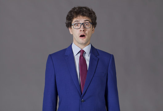 Guy in blue suit shoking