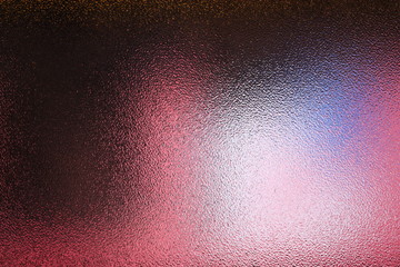 Frosted glass texture. Colorful lights background.