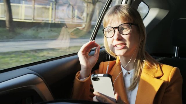 Young Woman Angry During a Phone Call in the Moving Car