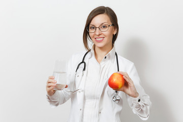 Smiling beautiful doctor woman with stethoscope, glasses isolated on white background. Female doctor in medical gown holding glass of water, red apple. Healthcare personnel, health, medicine concept.