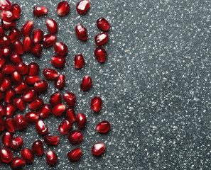 pomegranate seeds over black background