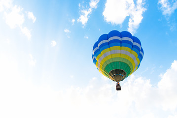 Hot air colorful Balloon flying in the blue sky.