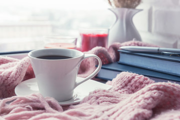 cup of coffee on a table in front of a window, the concept of breakfast and rest during work, a lifestyle of authentic, selective focus