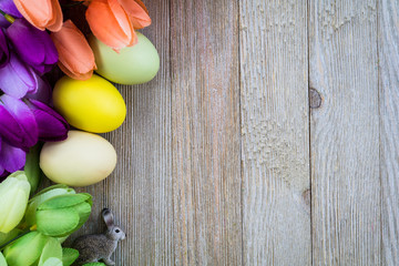 Spring and Easter background with tulips on wooden board, flat lay